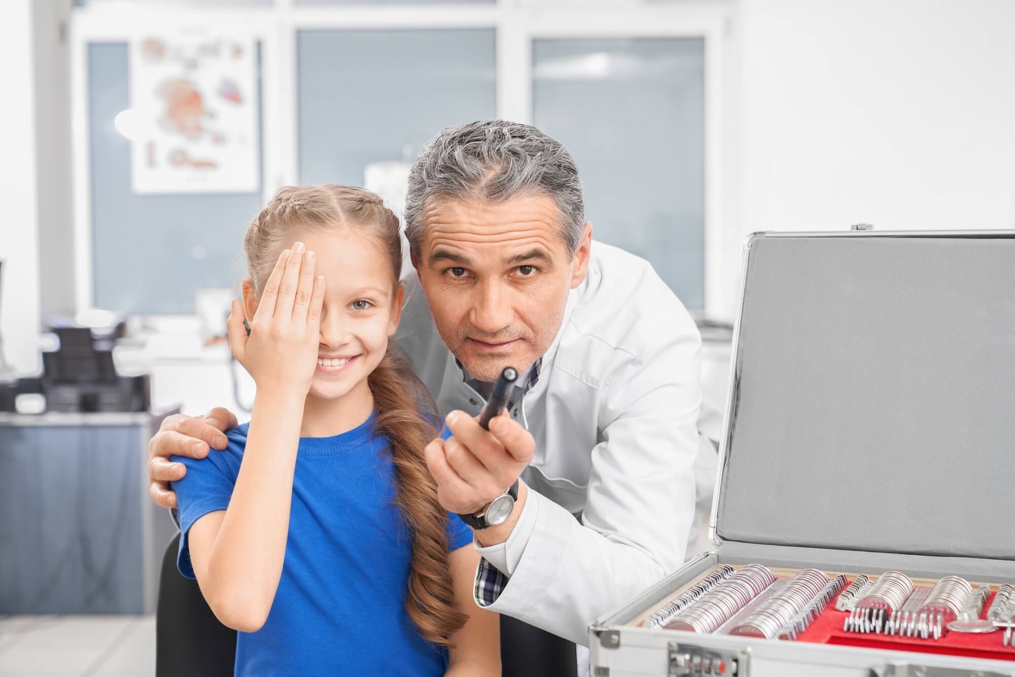 girl-closing-eye-with-hands-and-looking-at-camera-in-clinic-1.jpg